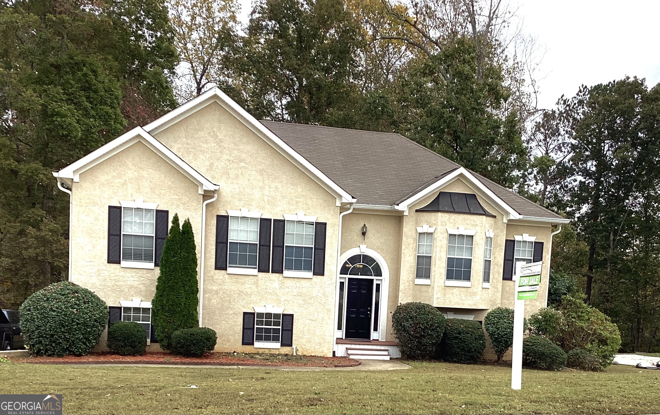 a front view of a house with a yard