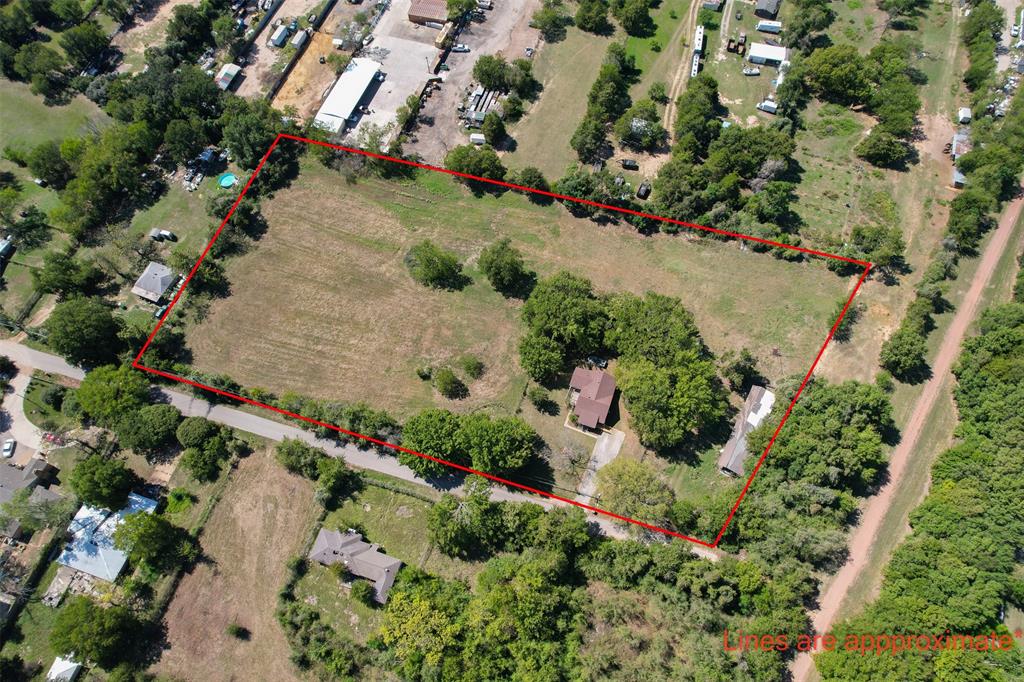 an aerial view of a house with a yard and flowers