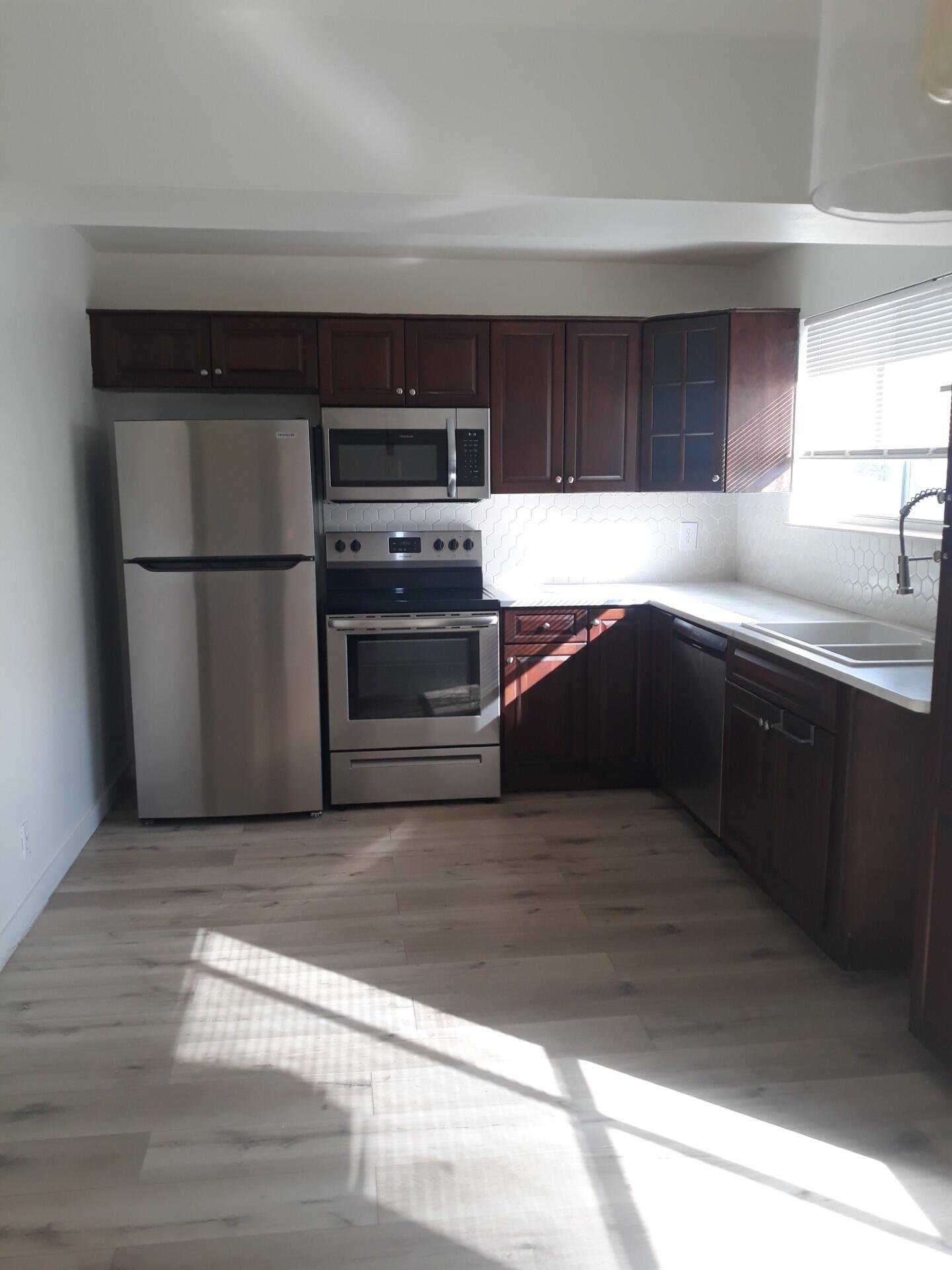 a kitchen with stainless steel appliances a refrigerator and a sink