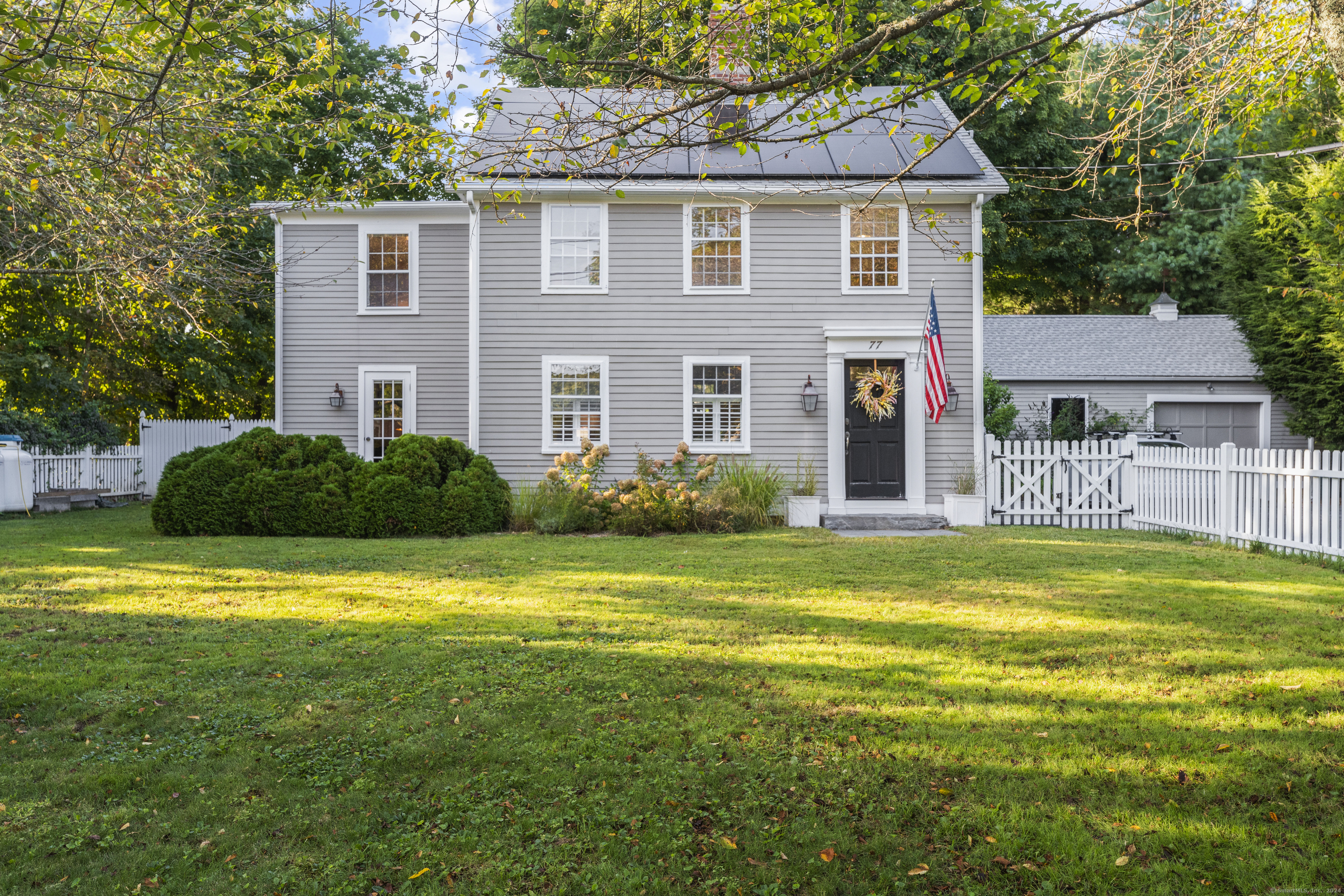 a front view of a house with a garden