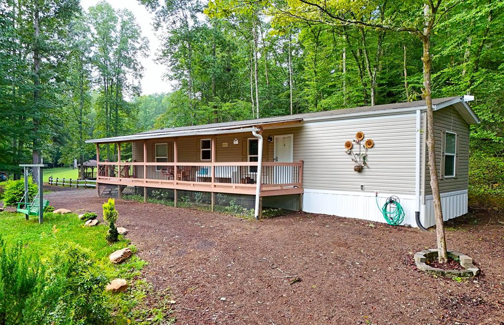 a view of house with backyard and sitting area