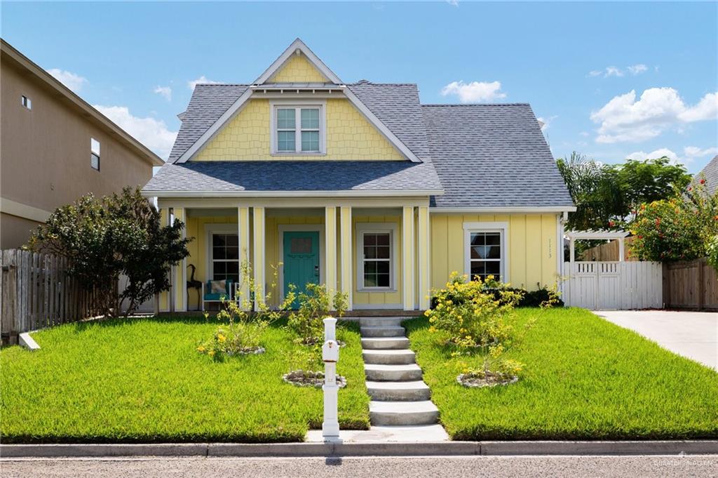 View of front of property featuring a front lawn and a porch