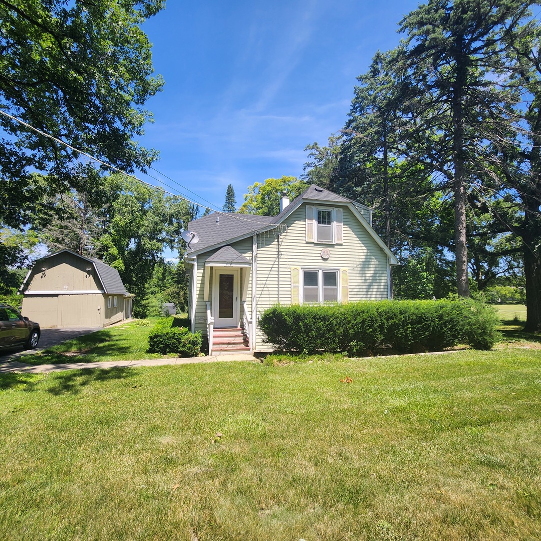 a front view of house with yard and green space