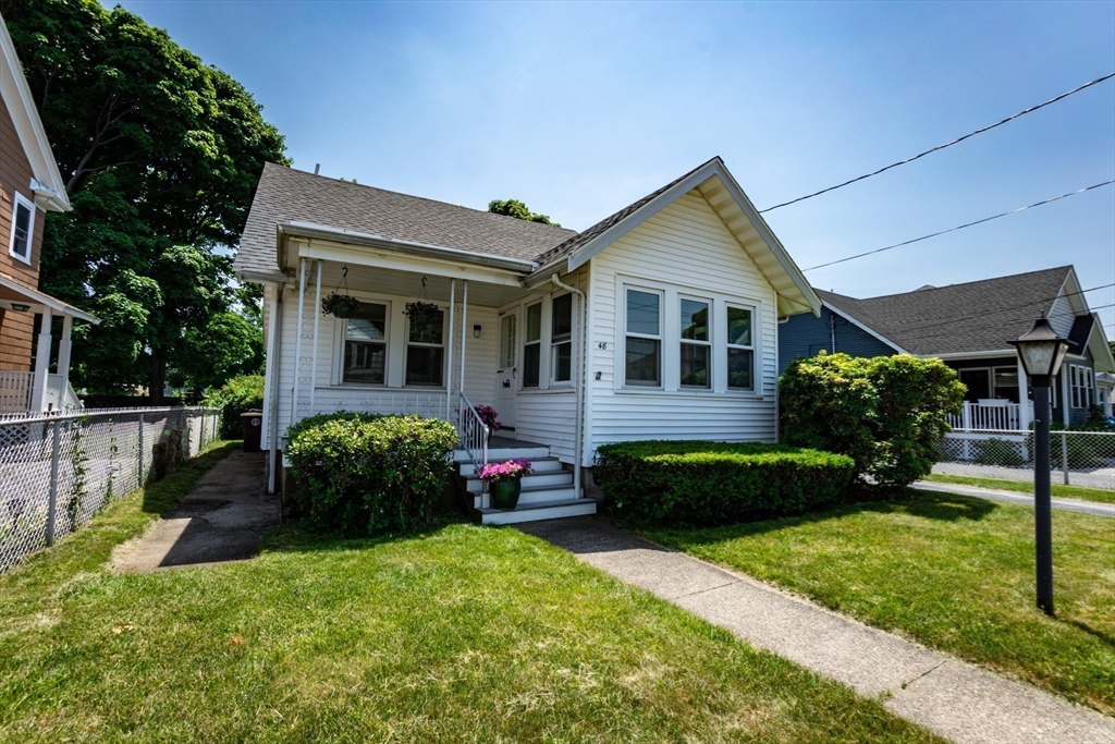 a front view of a house with a garden