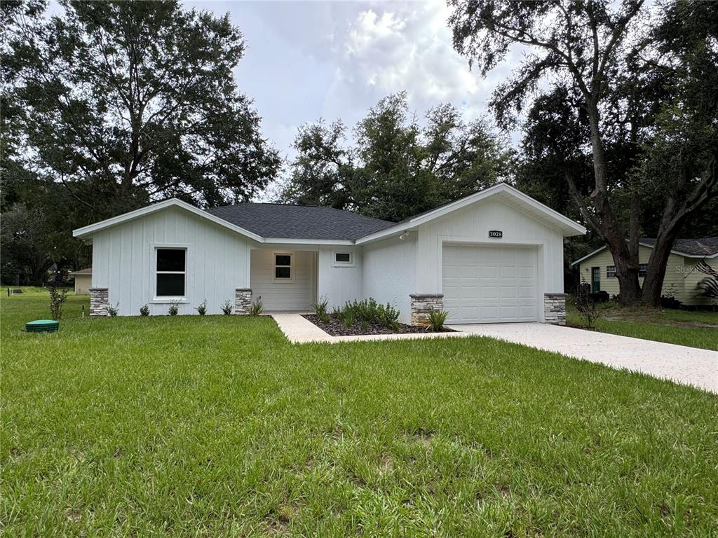 a front view of house with yard and green space