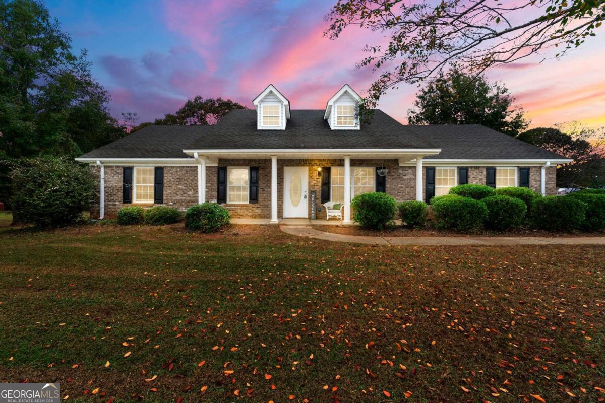 a front view of a house with yard and green space