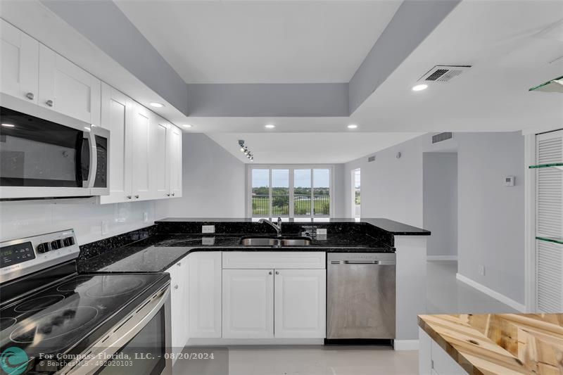 a kitchen with a sink stove and microwave