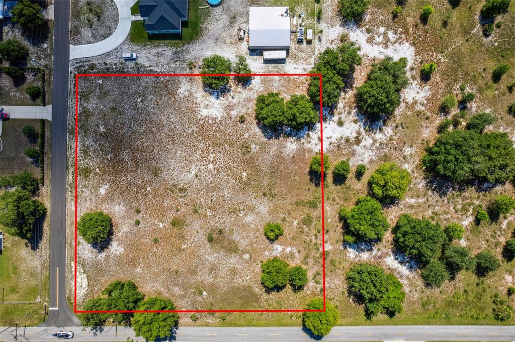 an aerial view of a house with a yard and garden