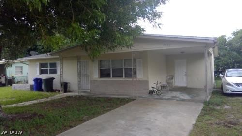 a front view of a house with a garden and yard