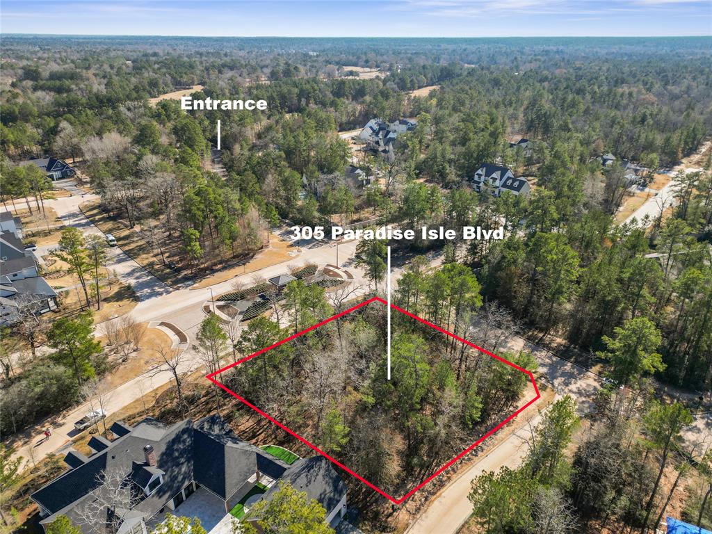 an aerial view of a houses with a yard