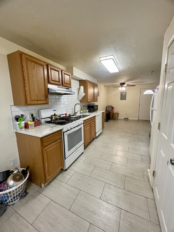 a kitchen with a sink a stove and cabinets