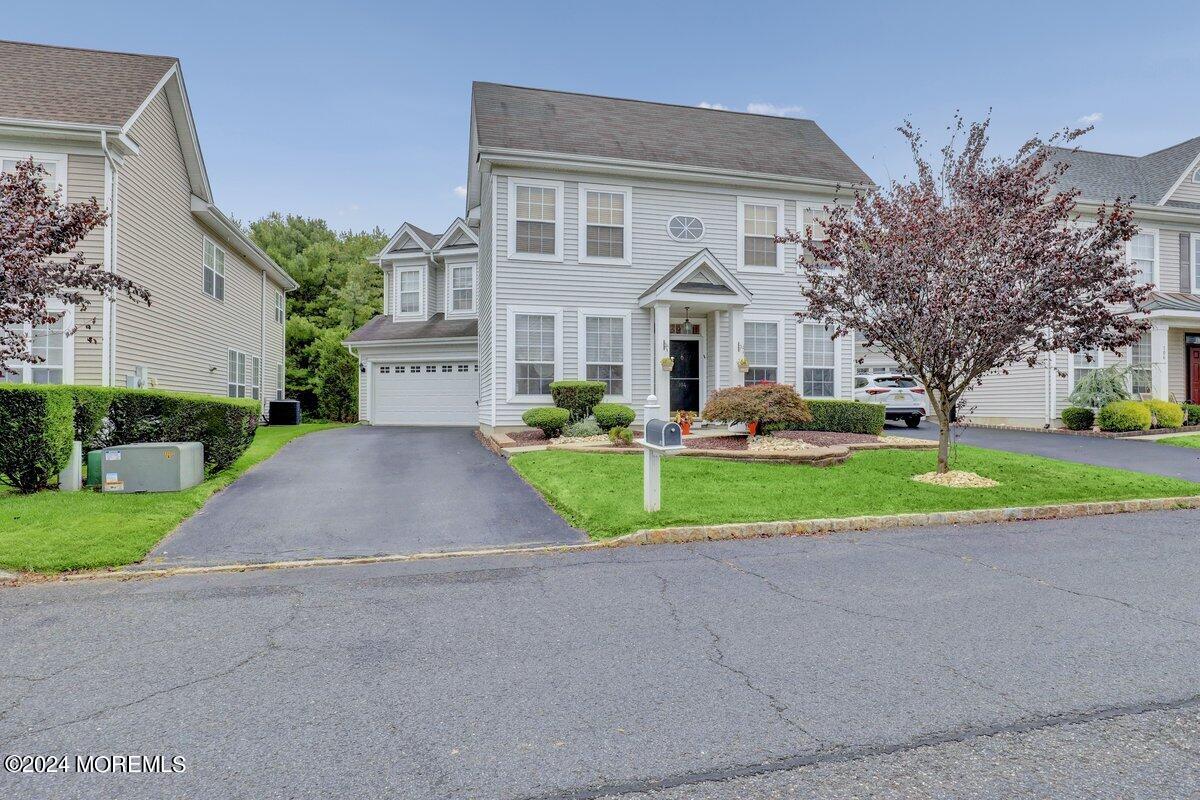 a front view of house with yard and green space