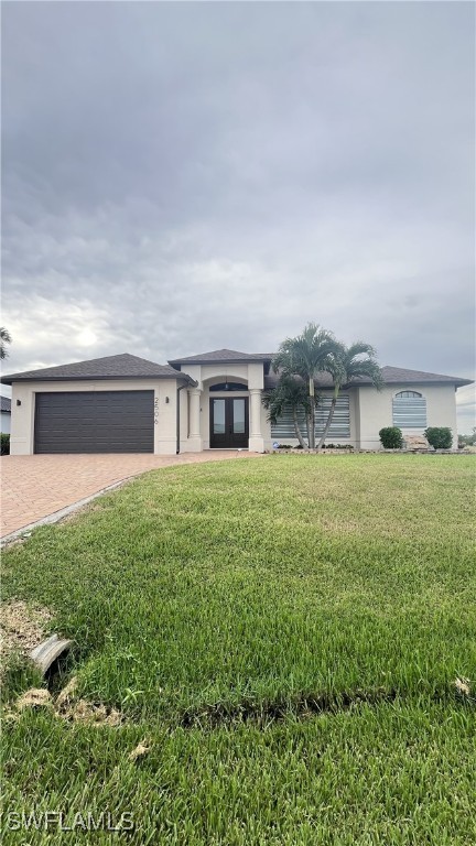 a front view of house with yard and green space