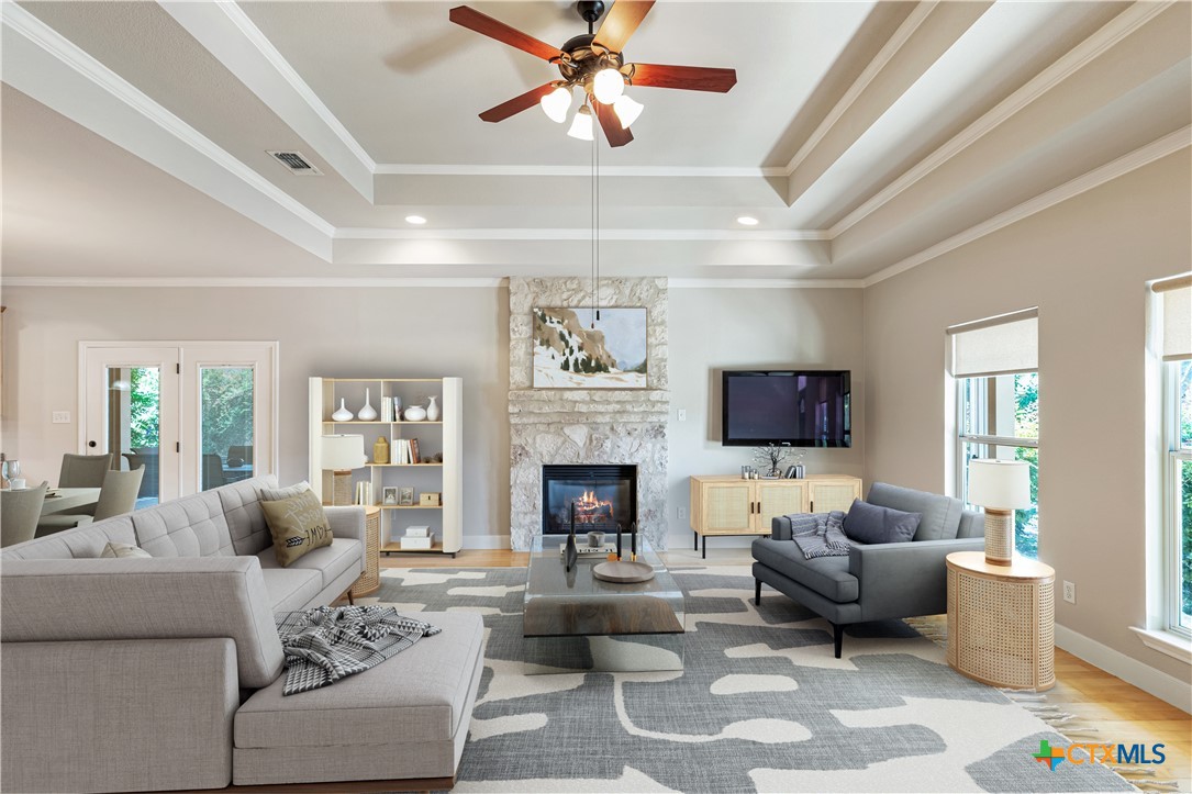 a living room with furniture a fireplace and a flat screen tv