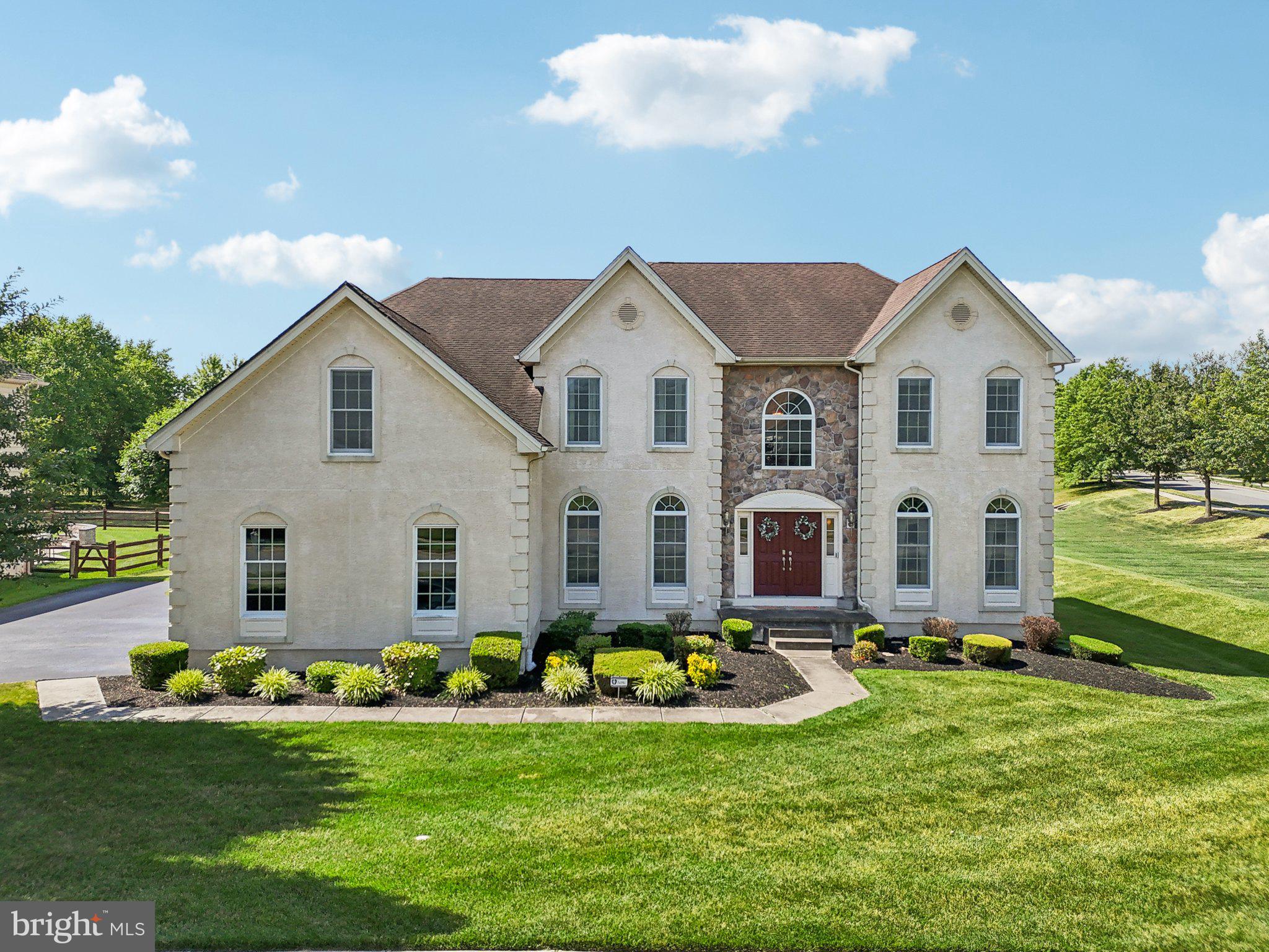 a front view of house with yard and green space