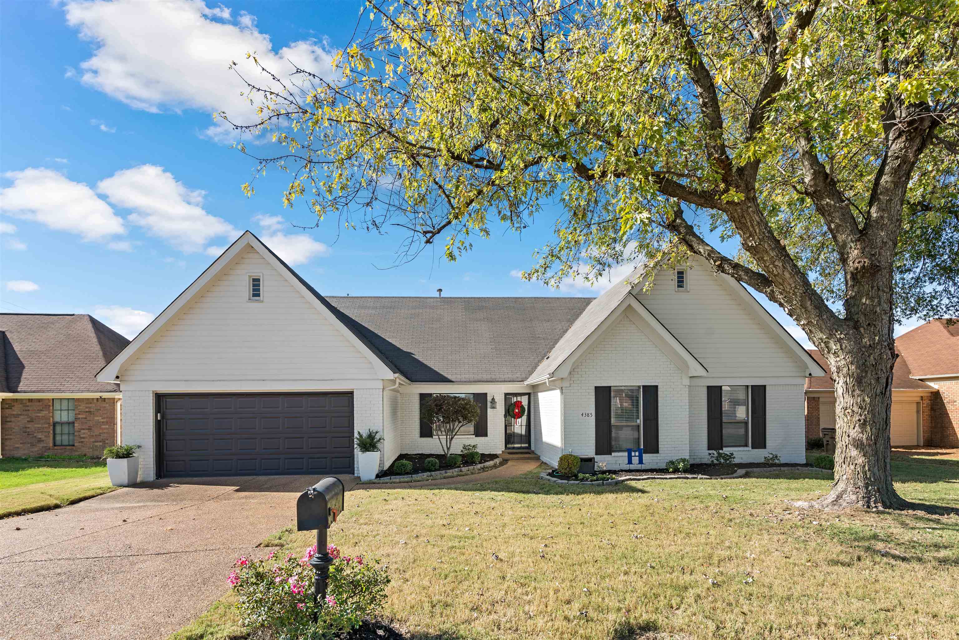 Beautifully landscaped with plenty of curb appeal, White brick with black shutters.