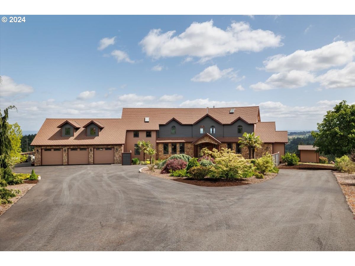 a view of a big house with a big yard and potted plants in front of it