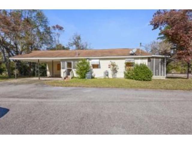 View of front of property featuring a carport, a s