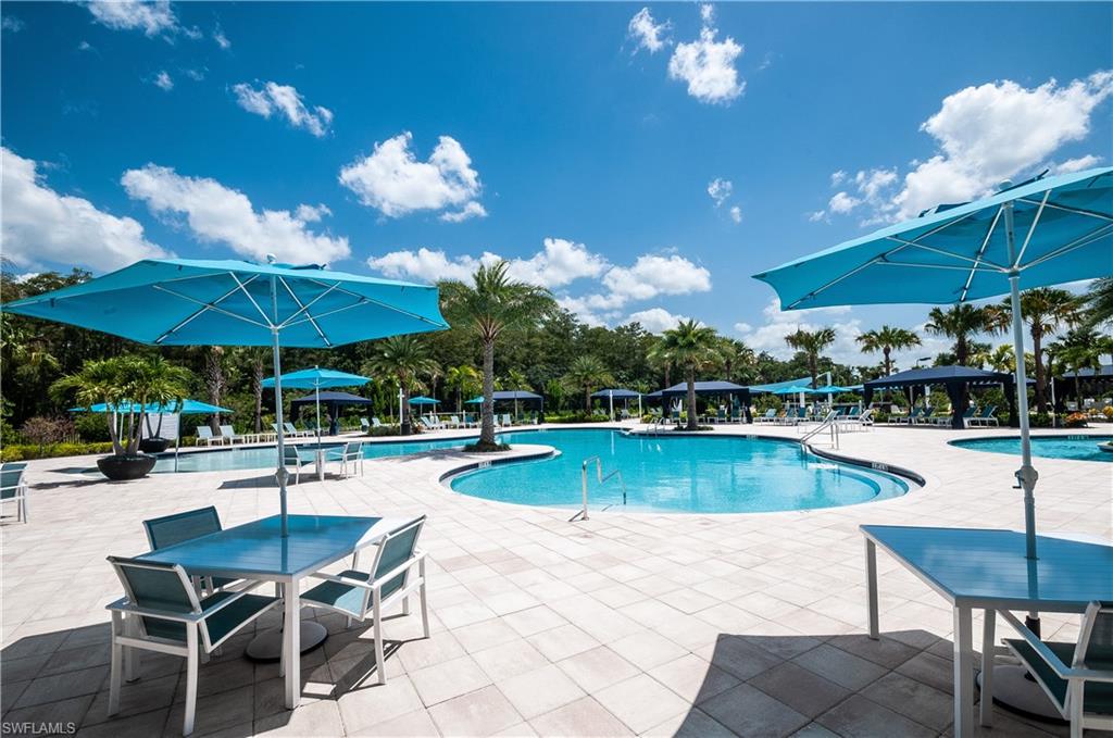 a view of a swimming pool with chairs in patio