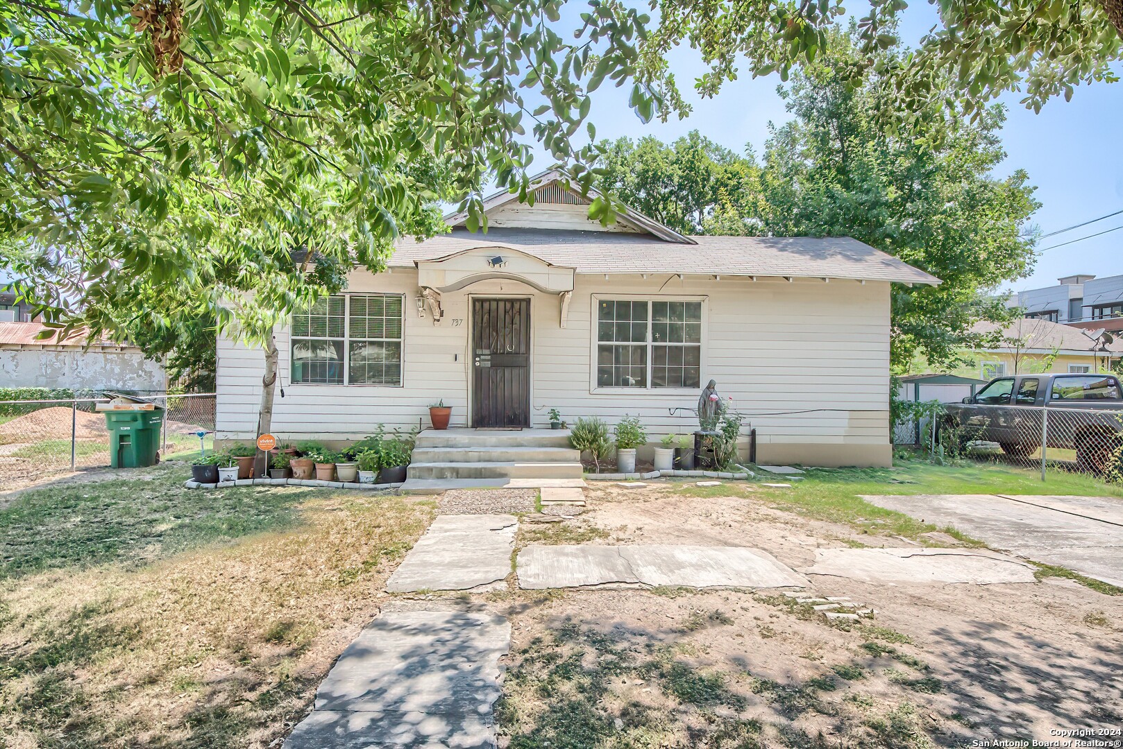 a front view of a house with a yard and trees