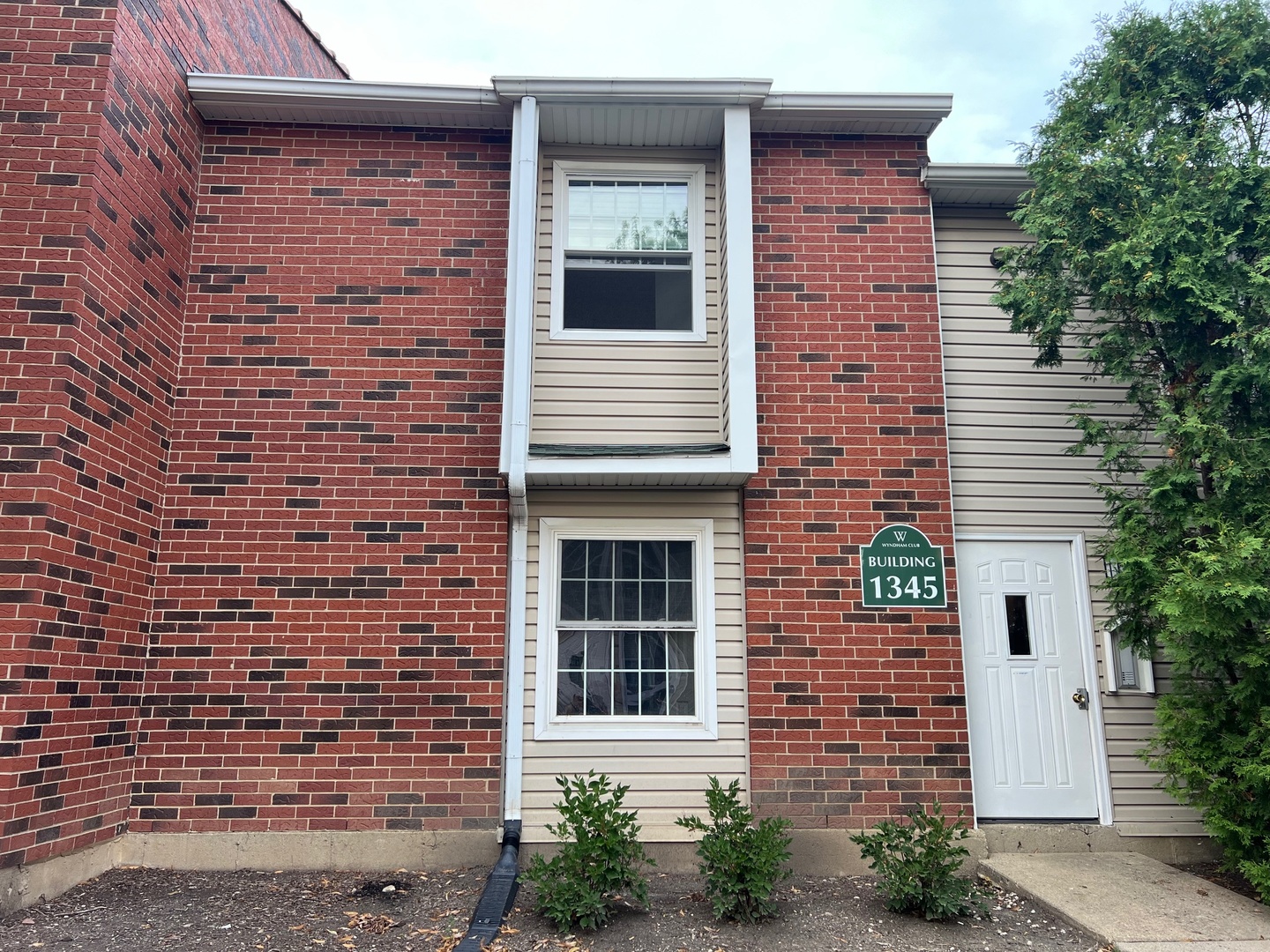 a view of a brick house with a large windows