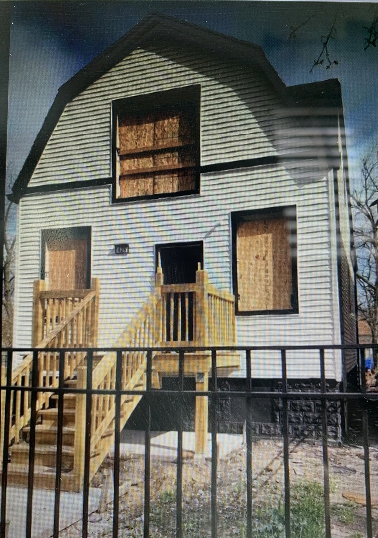 a front view of a house with wooden stairs