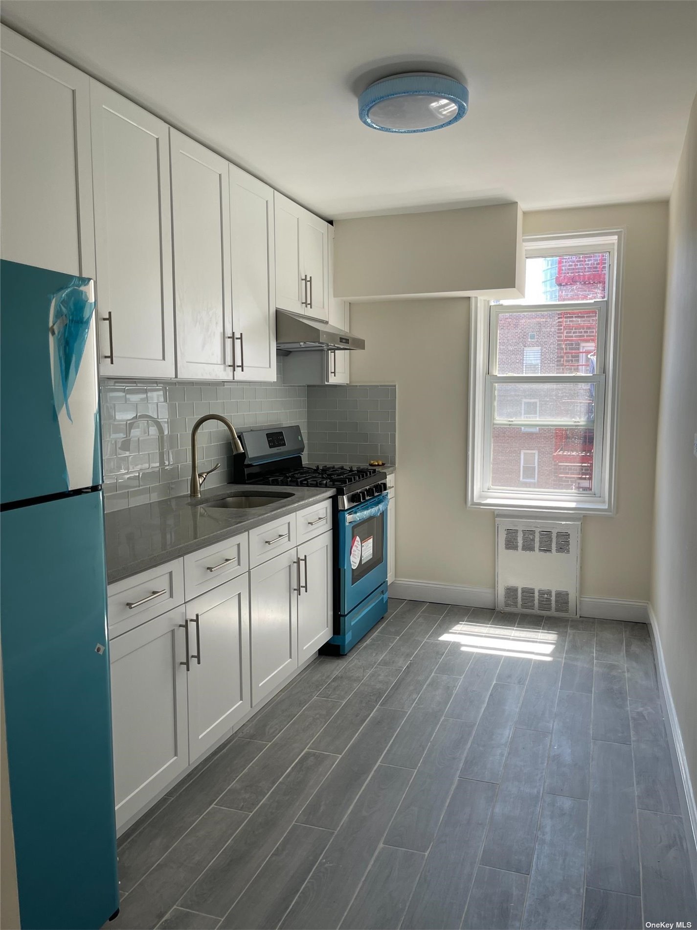 a kitchen with a sink a window and stainless steel appliances