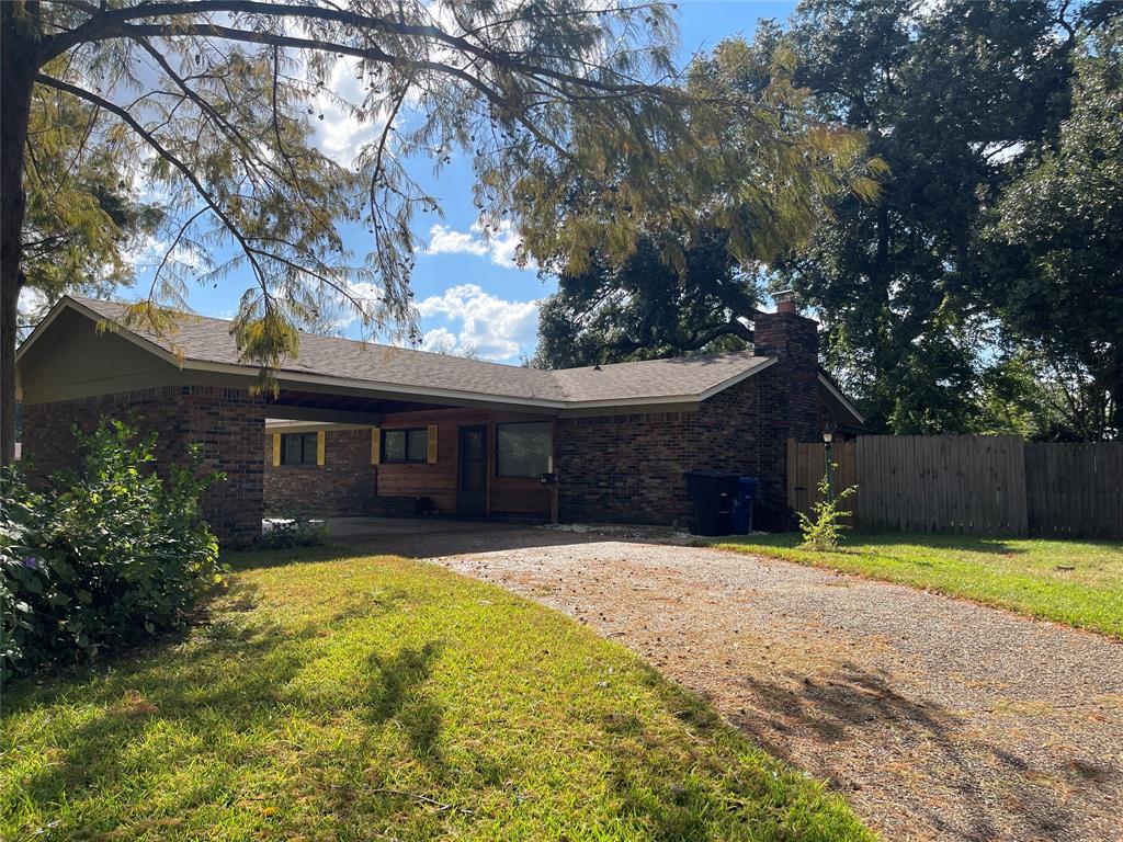 a brick house with trees in front of it