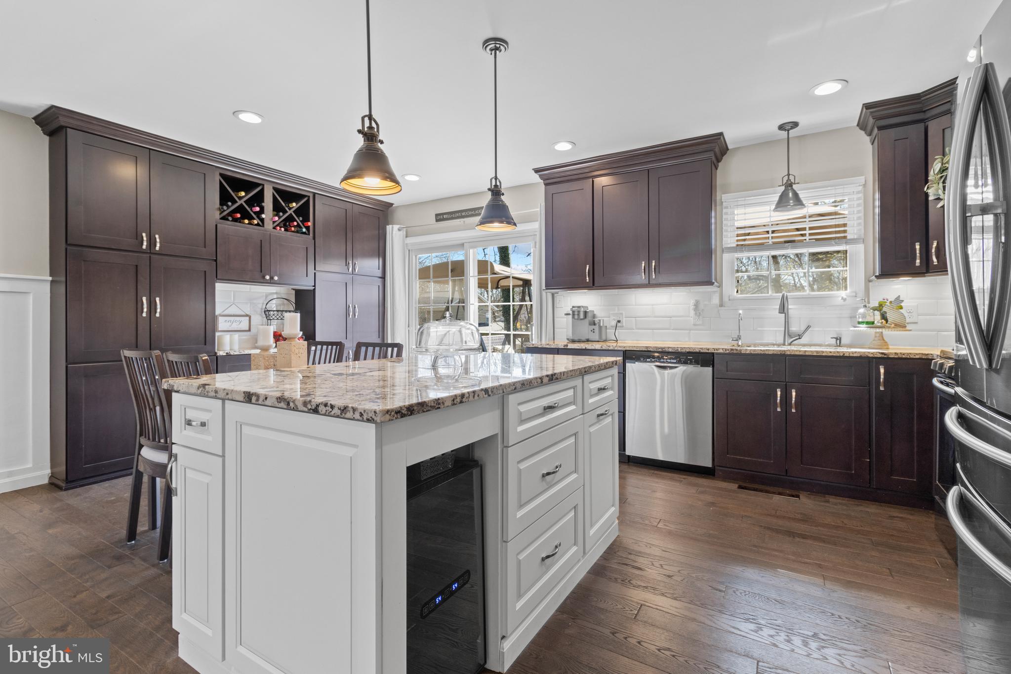 a kitchen with granite countertop a sink stainless steel appliances and cabinets