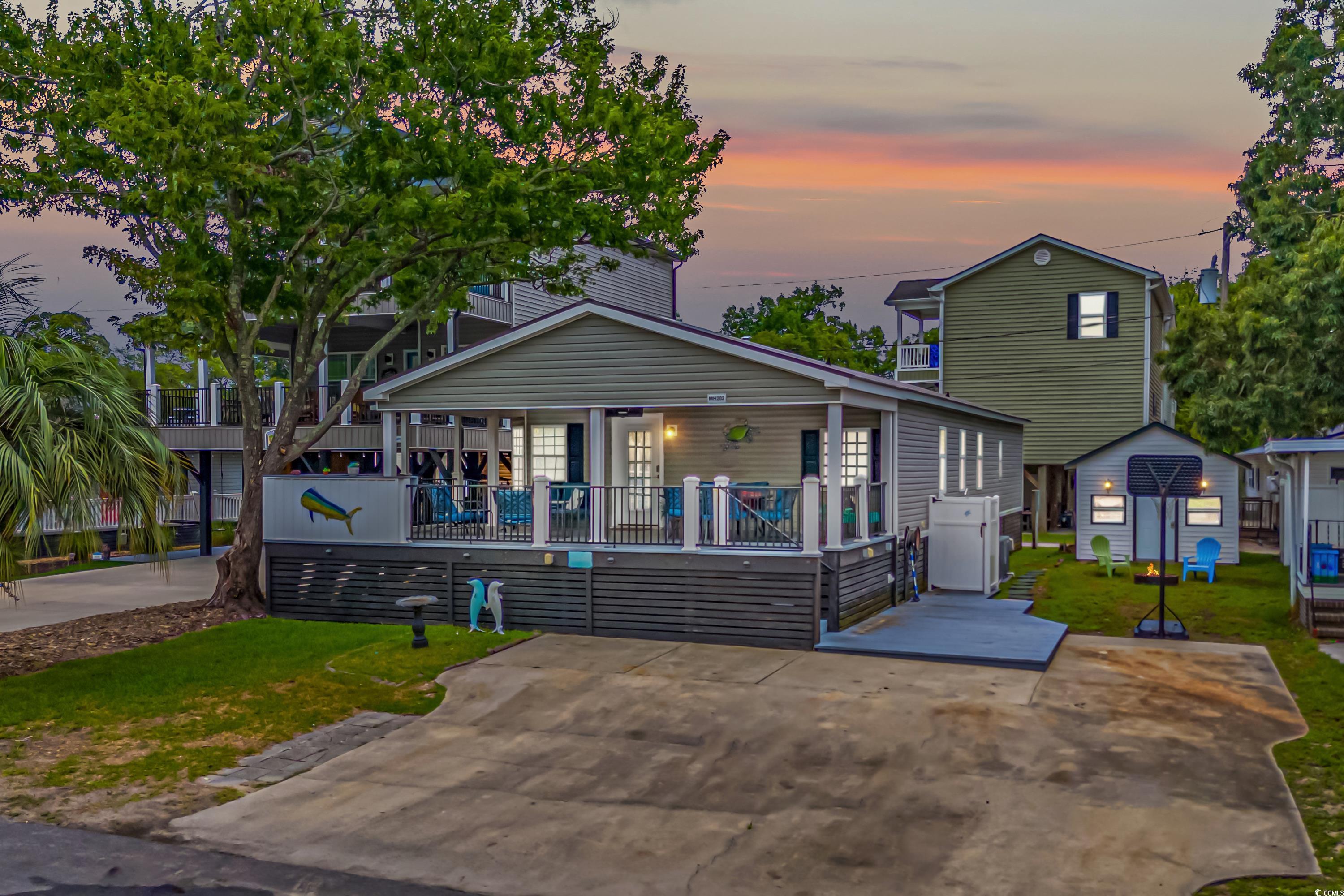 View of front of home featuring a yard and covered