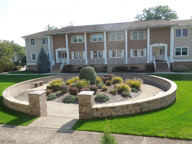 a front view of a house with a yard outdoor seating and garage