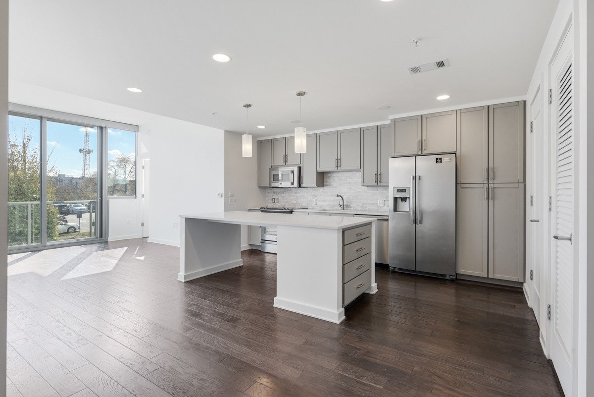 a kitchen with a refrigerator and a large window