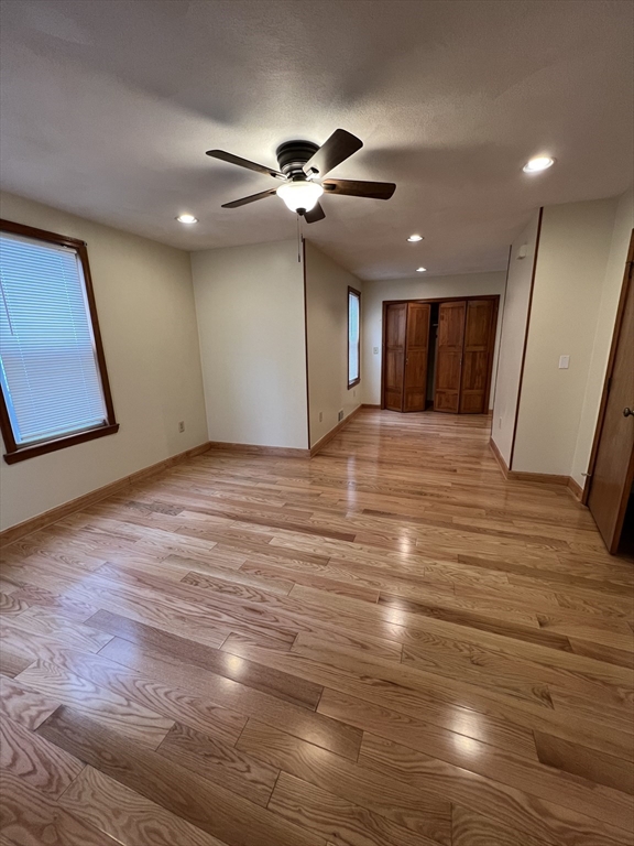 a view of a livingroom with a ceiling fan wooden floor and chandelier