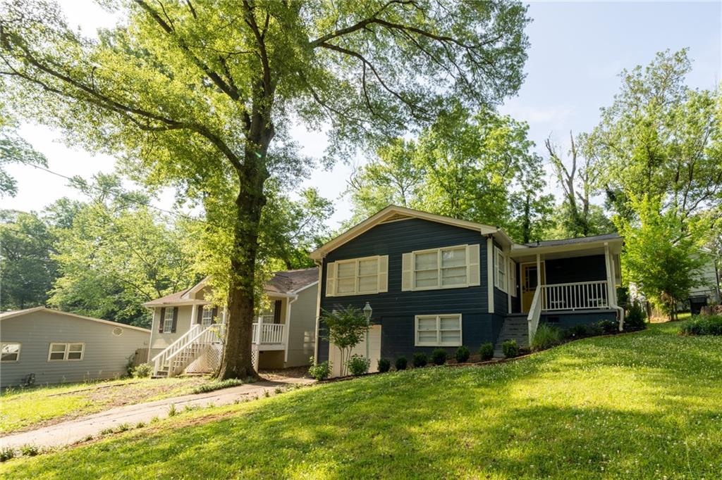 a view of a house with a yard