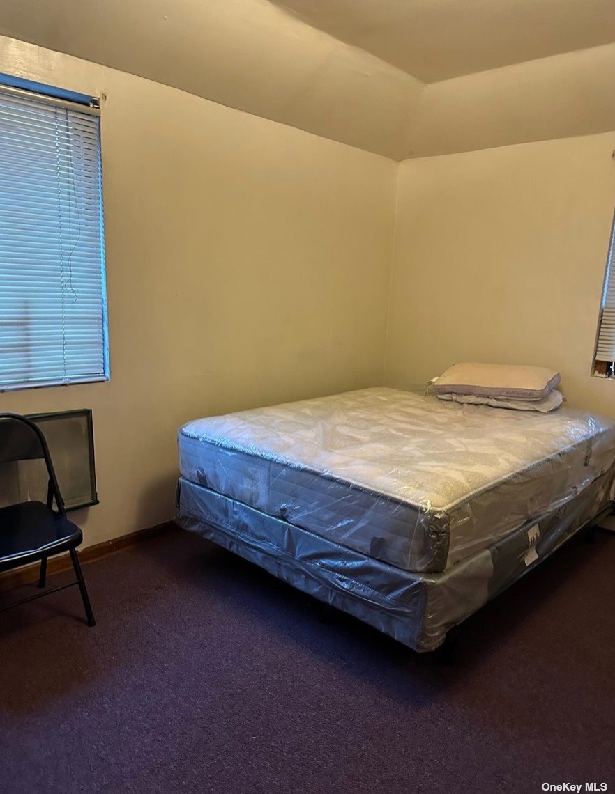 a bed sitting in a room next to a window