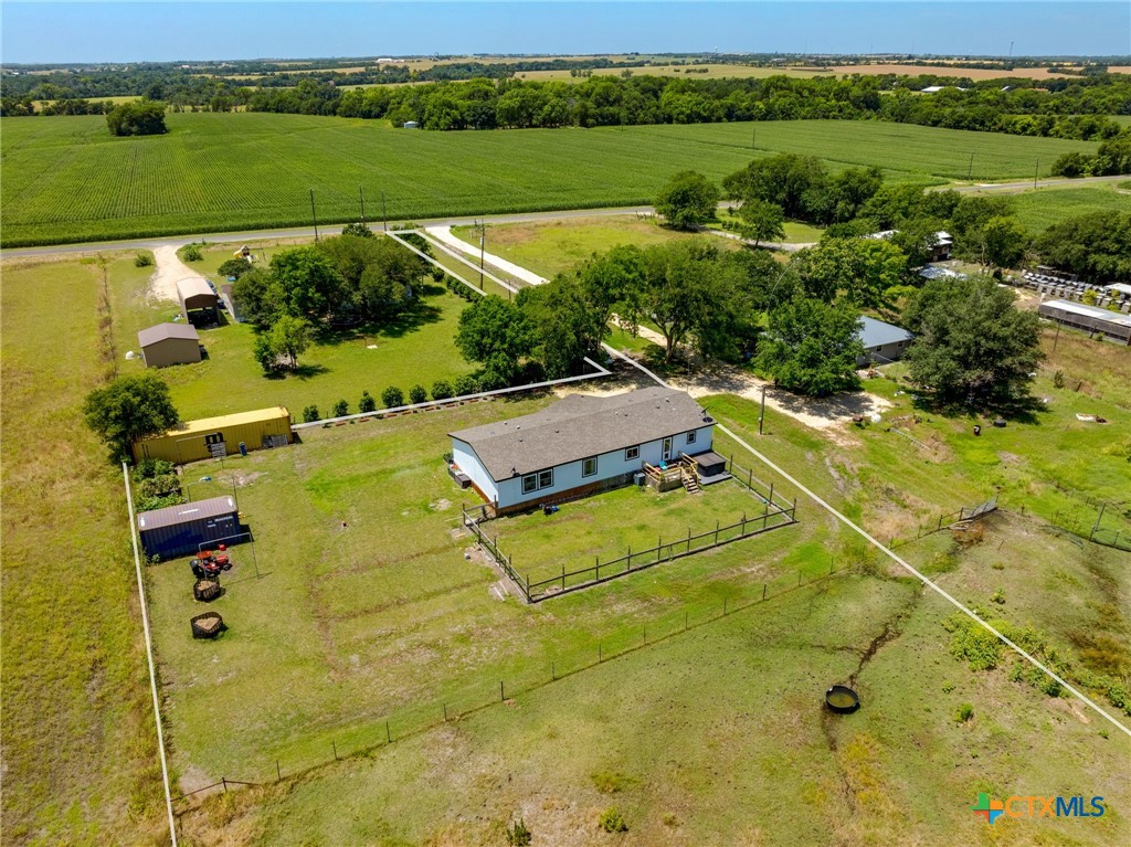 an aerial view of residential houses with outdoor space and city view