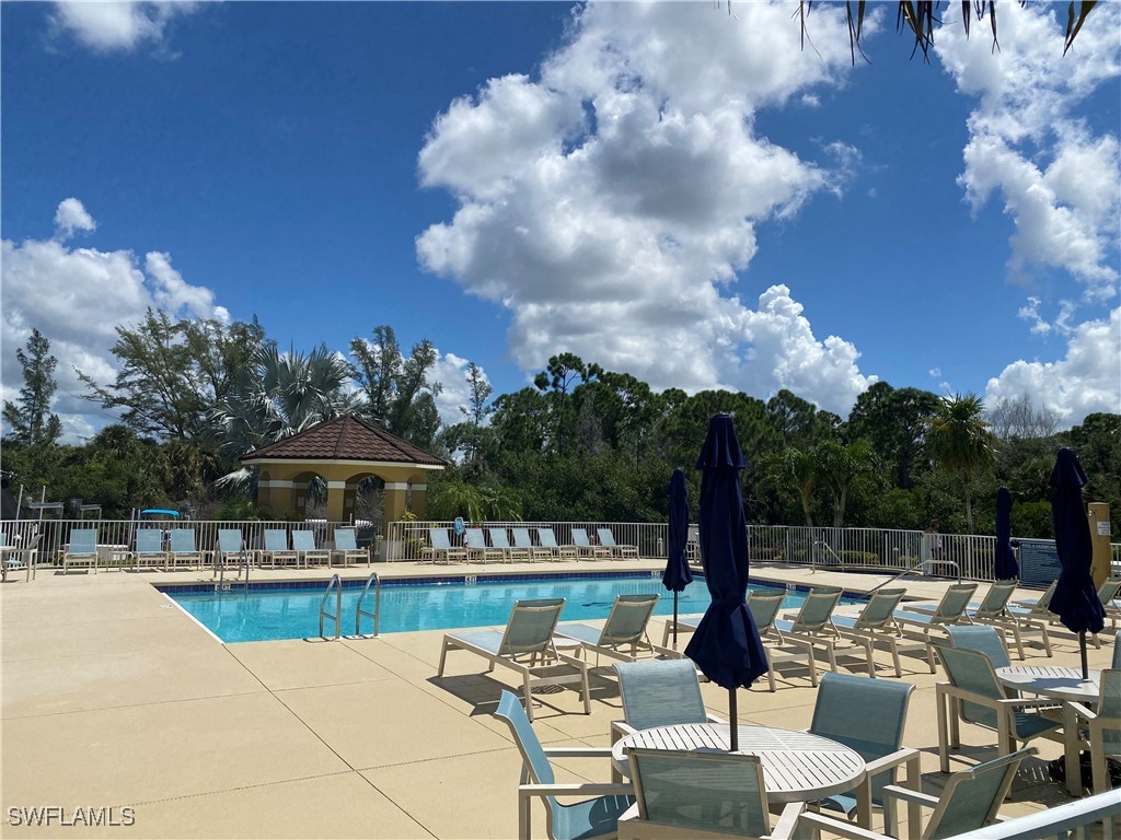 a view of a patio with swimming pool table and chairs