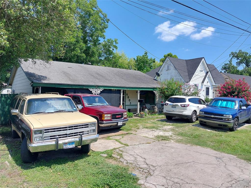 a front view of a house with cars parked