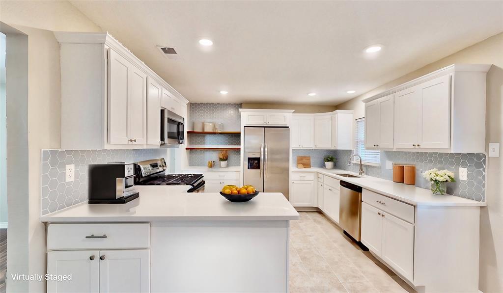 a kitchen with a sink a stove cabinets and counter space