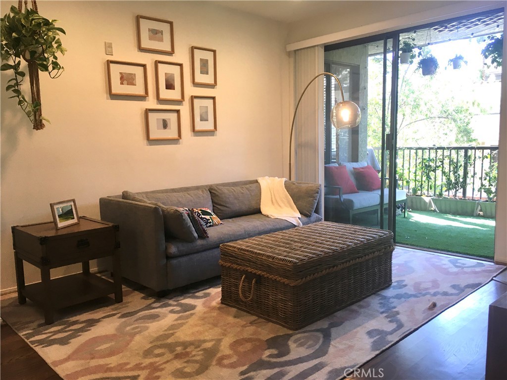 a living room with furniture and a floor to ceiling window