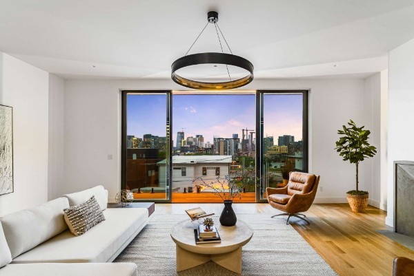 a living room with patio area and a large window