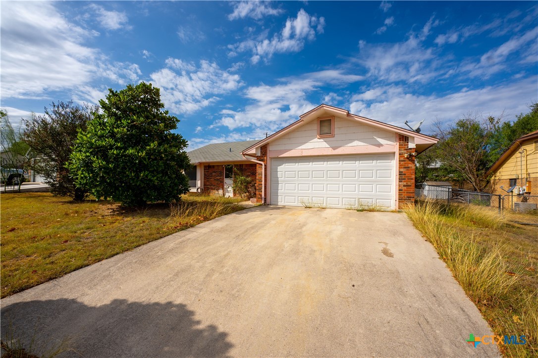 a front view of a house with a yard garage and outdoor seating