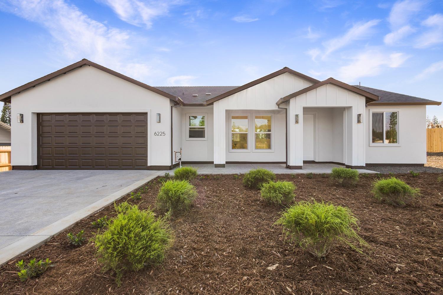 a view of backyard of house with yard and garage