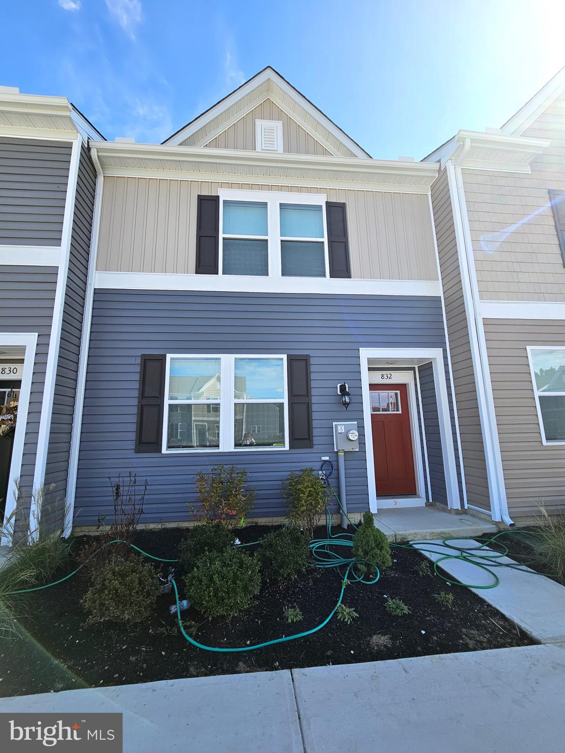 front view of brick house with a yard