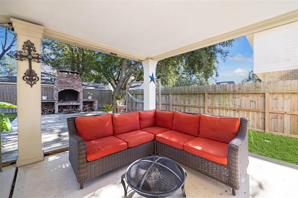 a outdoor living space with furniture and a fireplace