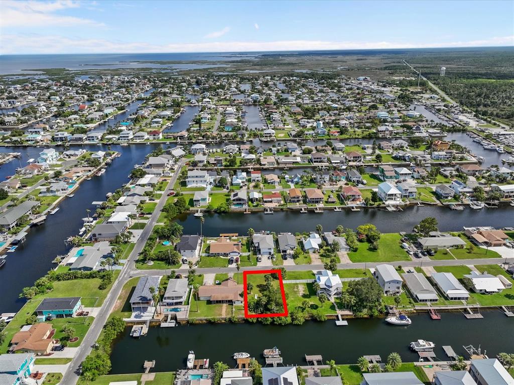 an aerial view of lake and residential building with outdoor space