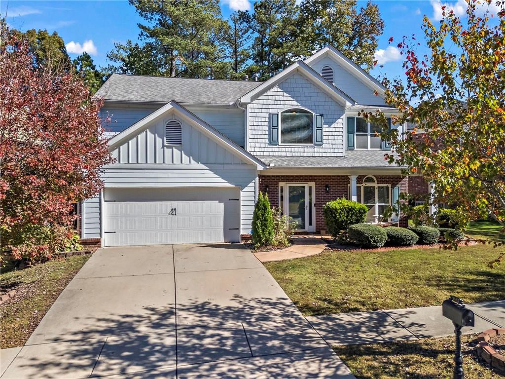 a front view of a house with a yard and garage