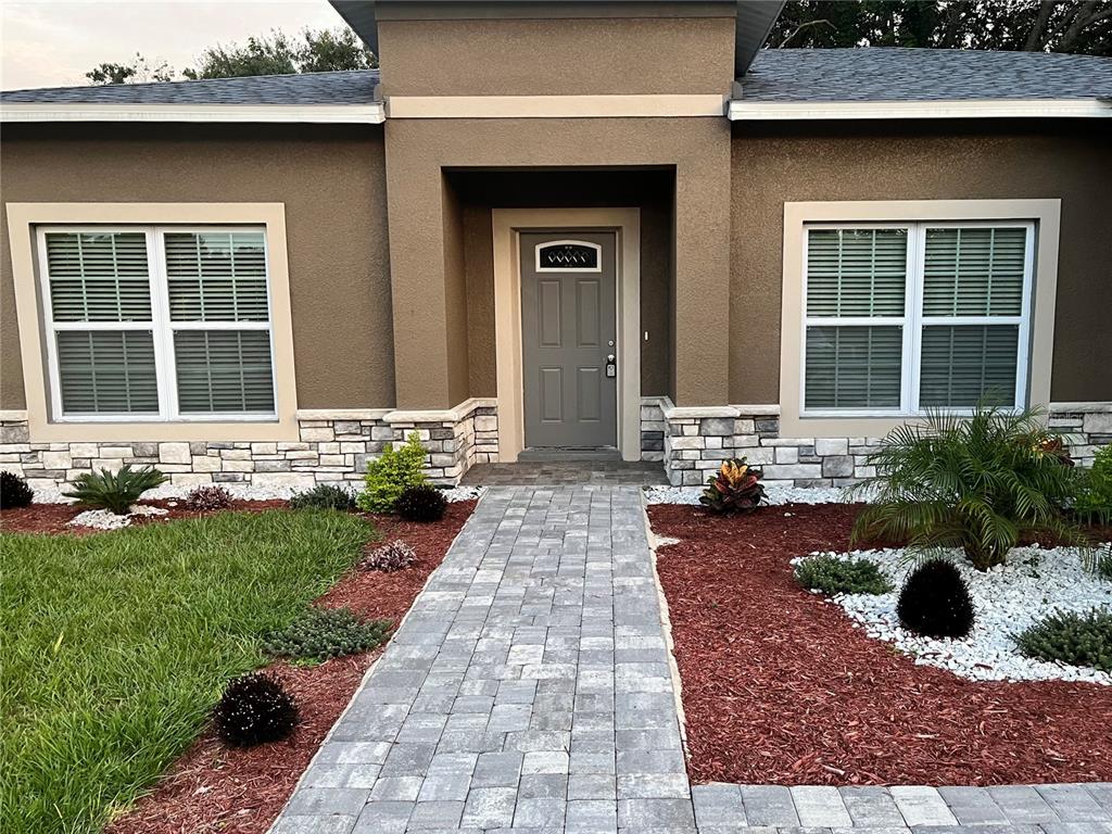 a front view of a house with a yard