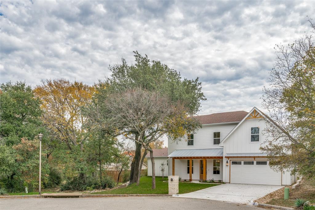 a view of house with outdoor space and garden