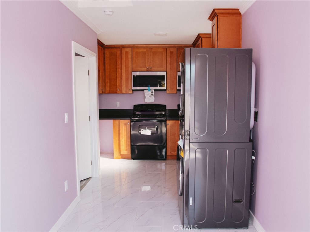 a kitchen with stainless steel appliances a refrigerator and a microwave